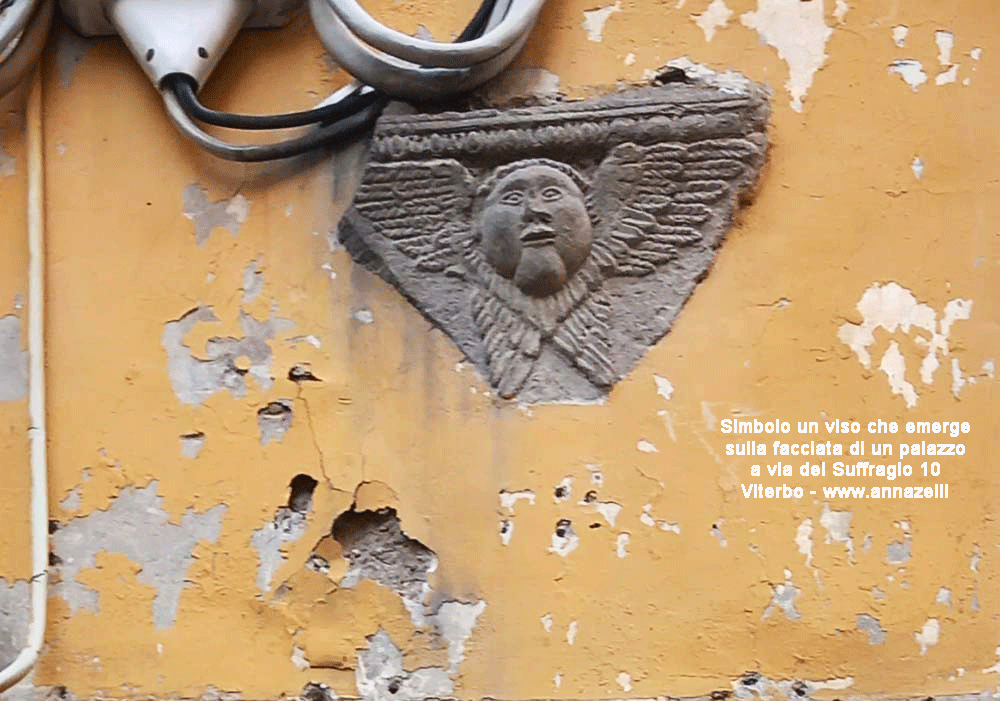 simbolo un viso con ali su facciata palazzo via del suffragio viterbo info e foto anna zelli